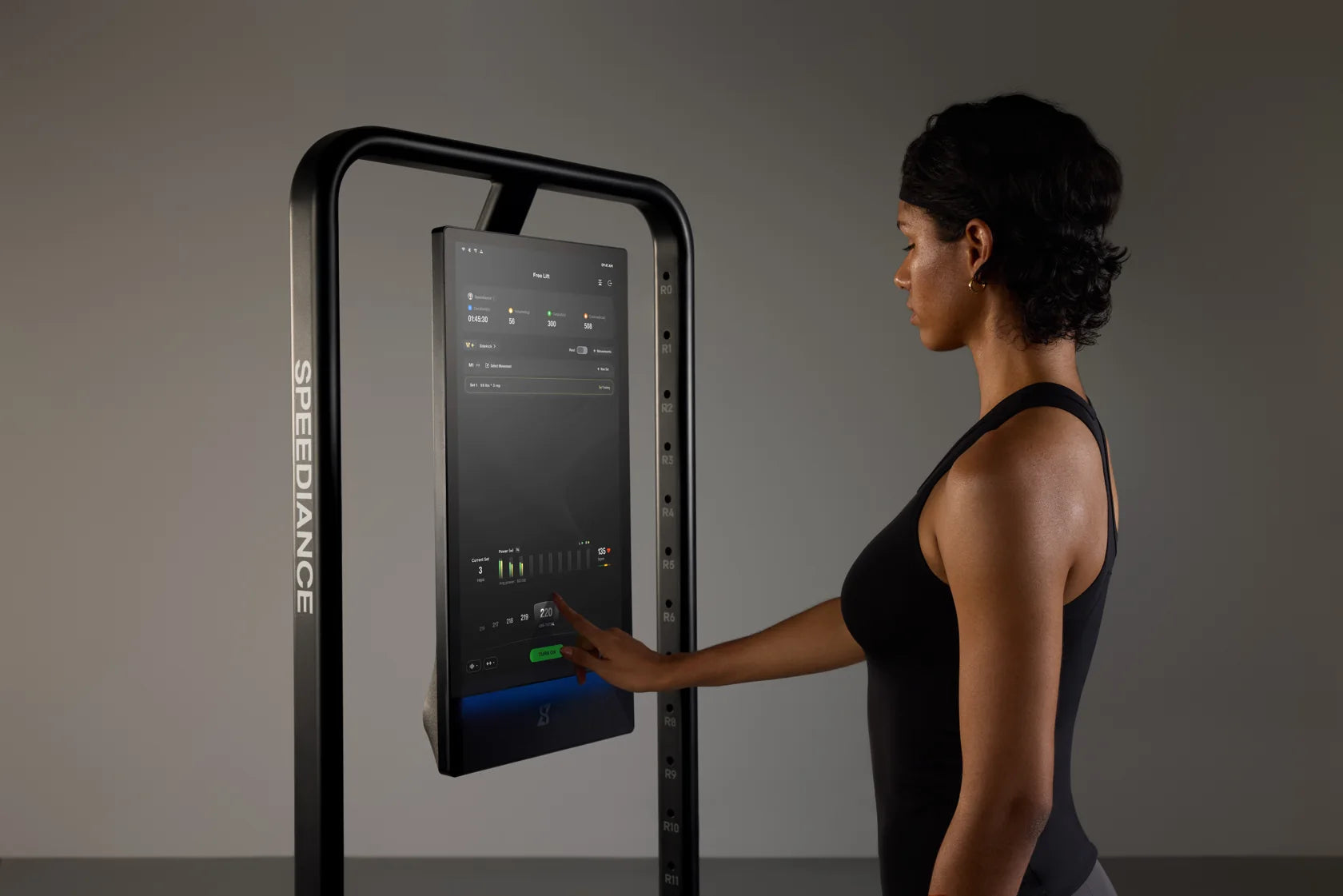 A woman adjusting the digital resistance on Gym Monster 3
