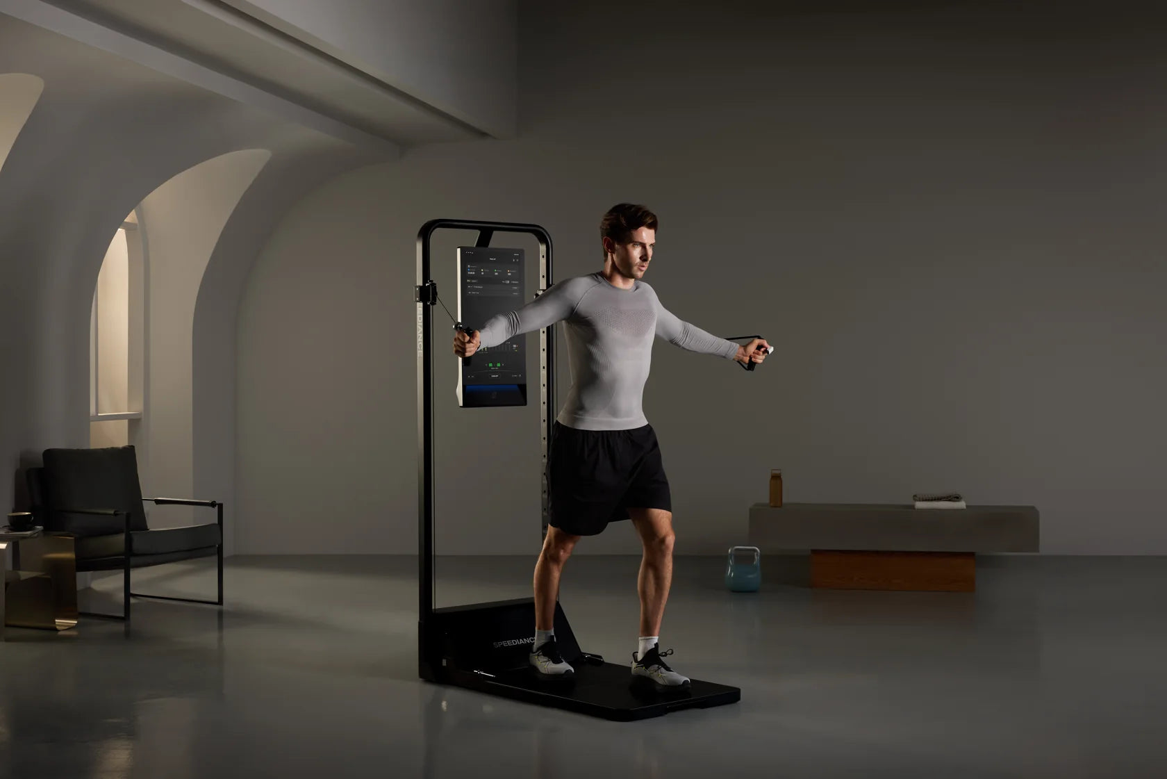 A man training on Gym Monster 3 in a calm, softly lit room